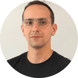 Tomasz Mysłek, Brand Strategy Lead at Adlook, in a professional headshot wearing glasses and a black shirt against a neutral background.